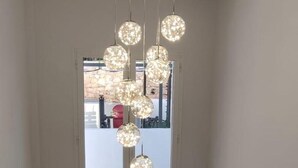 A staircase with a modern light fixture hanging from the ceiling. - Marbella Oasis Villa With 6 Bedrooms (Marbella)