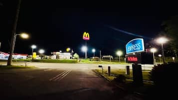 A McDonald's and Express Inn & Suites sign at night.