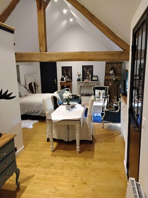 Relax in this inviting room with a comfortable bed, dining area, and cozy fireplace.
