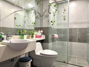 A bathroom with a sink, toilet, and shower. - 2 bedroom apartment 75m2, spacious, nice view, high speed wifi, full amenities. (Van Giang District)
