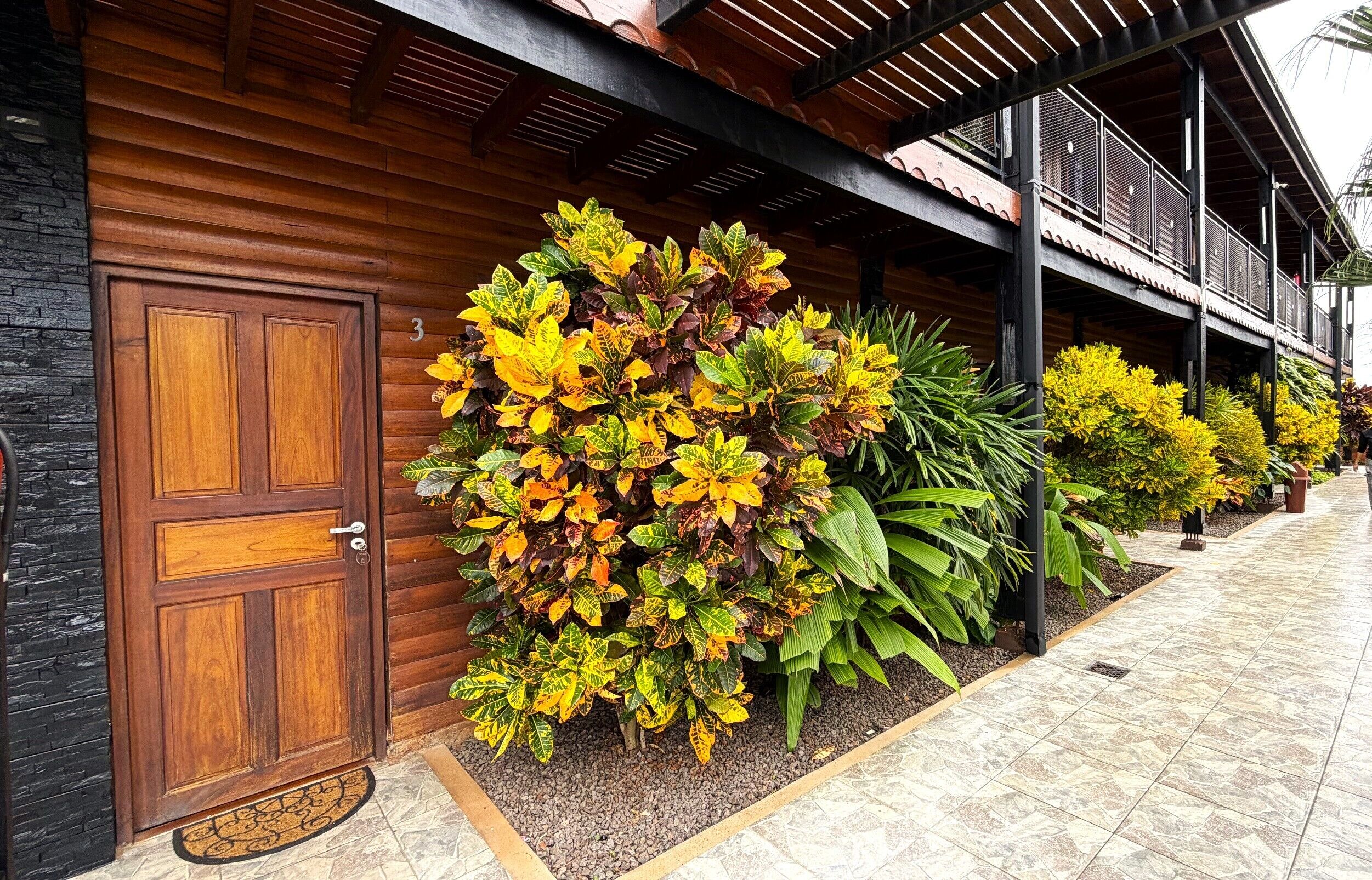 A wooden building with a large door and a covered walkway.