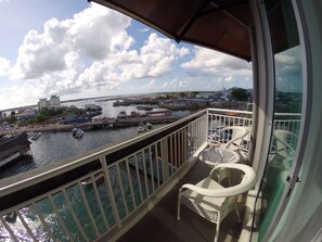 A balcony with a view of a marina, including boats and buildings. - Pacific Inn (Semporna)