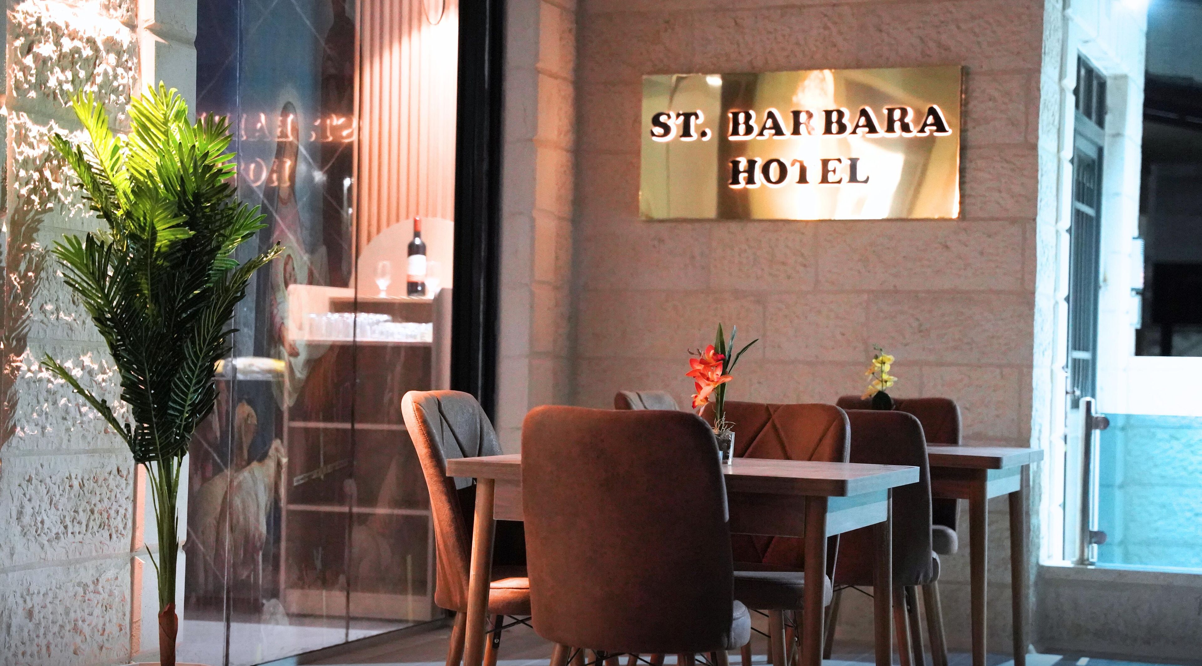 An indoor seating area with a sign reading "ST. BARBARA HOTEL".