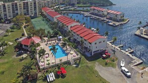 An aerial view of a resort with multiple buildings, a swimming pool, and a marina. - Charming Bayside 2 bed, 2 bath Condo at Futura in Islamorada WiFi, Pool, Dockage (Tavernier)