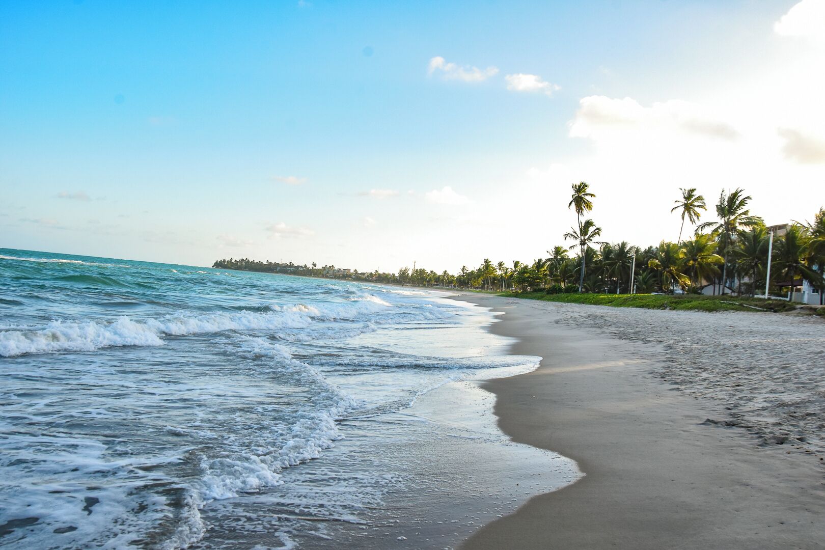 On the beach, white sand, sun loungers, beach umbrellas