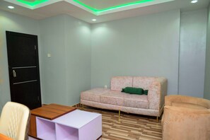Luxury Apartment | Living area | 32-inch Smart TV with satellite channels - Goddis Apartments Ajah (Lekki)