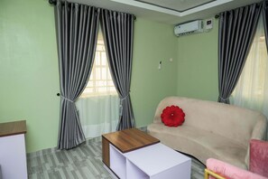 Superior Apartment | Living area | 32-inch Smart TV with satellite channels - Goddis Apartments Ajah (Lekki)