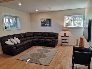 Relax in this inviting living room with a comfortable sofa, patterned rug, and flat-screen TV.