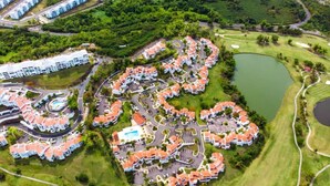 An aerial view of a residential area with a golf course, a swimming pool, and a lake. - Rio Grande  Rio Mar cluster 2,Vista Del Mar- View (Río Grande)