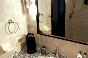 A bathroom with white tiled walls, a large mirror, a black coffee maker, a soap dispenser, and a towel ring. - Rio Grande Rio Mar cluster 2,Vista Del Mar- View (Río Grande)