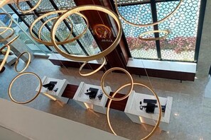 A display of circular light fixtures in a modern interior setting. - Grand Flora Hotel (Melaka)