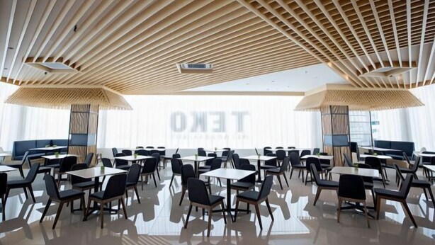 A spacious dining area with multiple tables and chairs, a modern ceiling design, and large windows allowing natural light. - Grand Flora Hotel (Melaka)