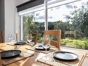 Enjoy a romantic dinner for two in this serene room with a garden view.