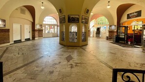 A spacious lobby with high arched ceilings, a central decorative column, and a Burger Bar on the right. - Manitou Incline Retreat

 (Manitou Springs)