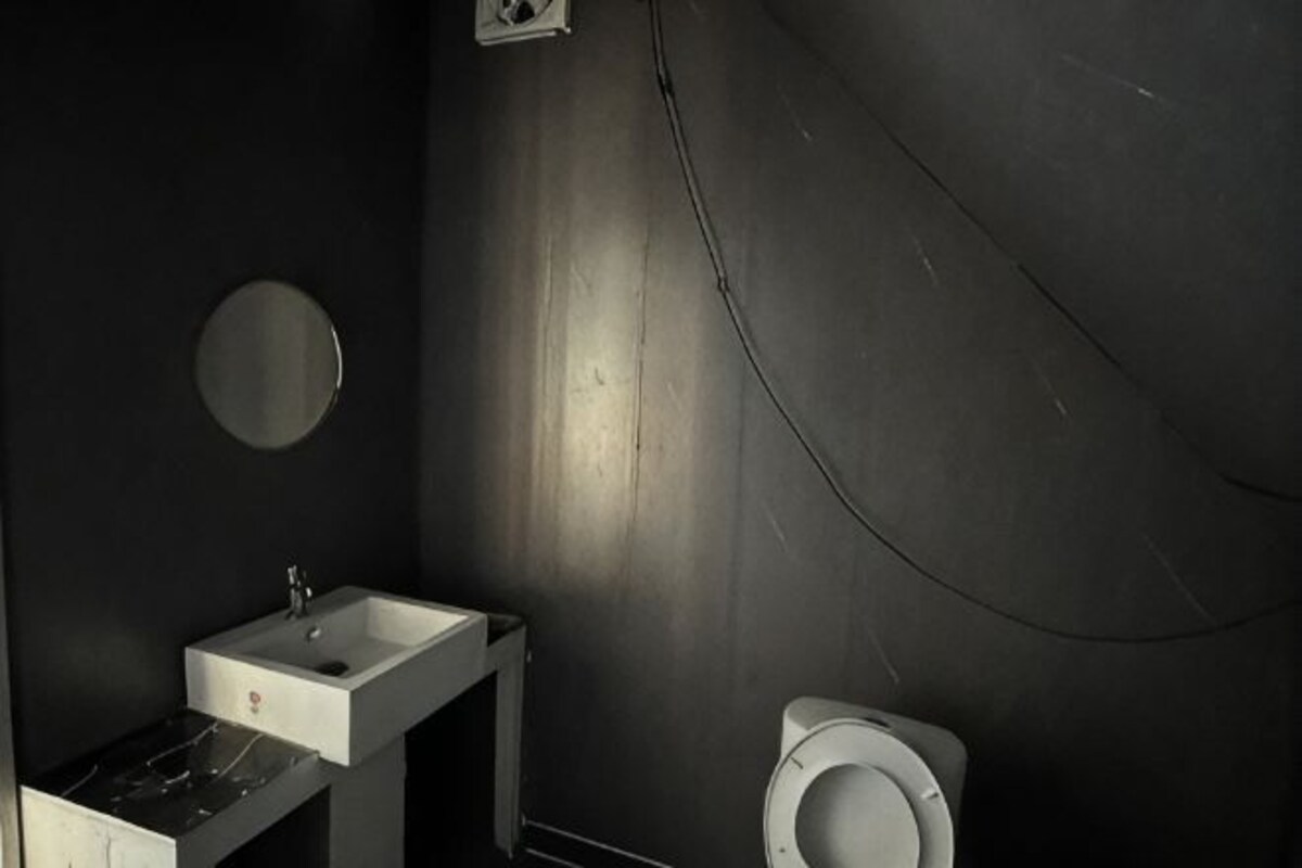 A bathroom with a sink, mirror, and toilet.