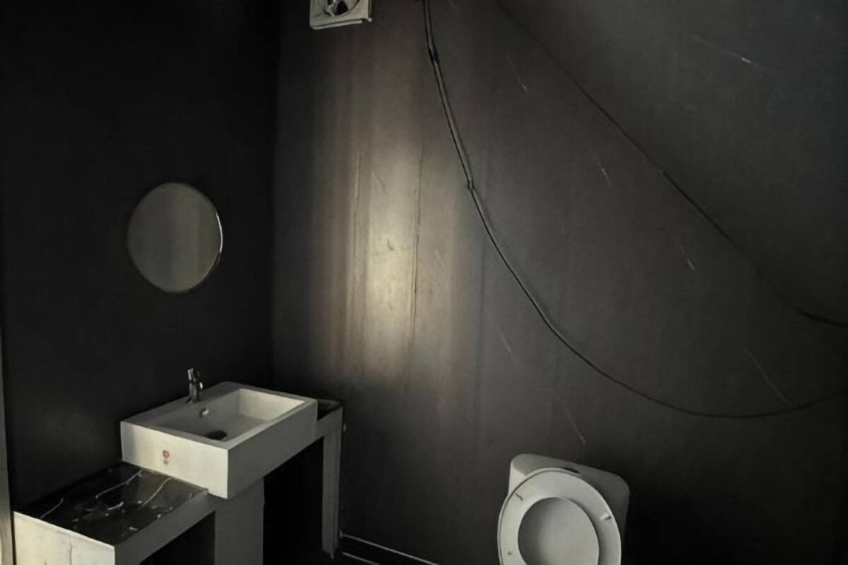 A bathroom with a sink, mirror, and toilet.