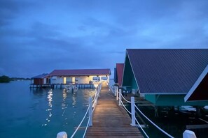 A wooden pier leading to overwater bungalows with a calm water body in the background. - Adil Waterhouse Resort (Bum Bum Island)