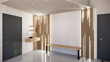 A modern hallway with a bench, a wooden shelf with books, and two doors.