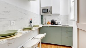 A compact kitchen with a microwave, toaster, and coffee maker. - TheBlueStay 244 - Stylish Studio - Paris 12 (Paris)