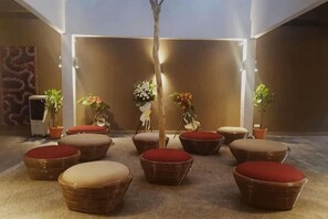A lobby with wicker furniture, potted plants, and a modern design. - Rebungan Resort Langkawi (Langkawi)