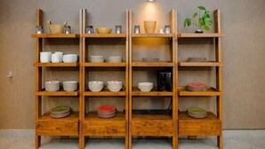 A wooden shelving unit with various dishes and kitchenware. - Rebungan Resort Langkawi (Langkawi)