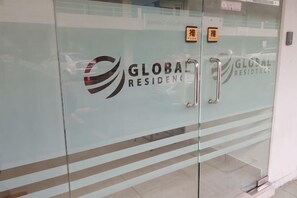 A glass door with the 'GLOBAL RESIDENCES' logo and a handle. - Global Residency (Kota Kinabalu)