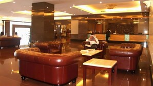 A hotel lobby with leather seating, a reception desk, and a modern chandelier. - Imperial Hotel Miri (Miri)