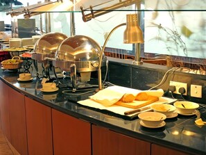 A buffet setup with food containers, a coffee machine, and a lamp. - Imperial Hotel Miri (Miri)
