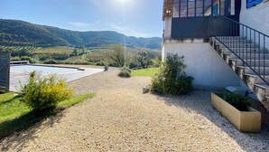 A building with a staircase, a pool, and a view of a valley.