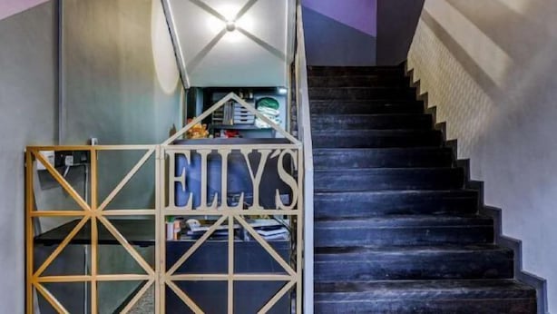 A staircase with a wooden gate labeled "ELLY'S" leading to a room. - Ellys Home (Semporna)