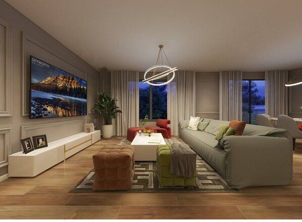 A modern living room with a large flat-screen TV, a sofa, a coffee table, and a red chair.