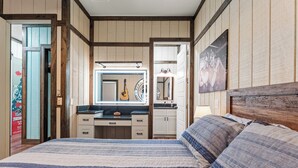 A bedroom with a bed, a dresser, a mirror, and a guitar. - "The Florida Cracker "THE GREEN ROOM" READ our five stars review.. (Brooksville)