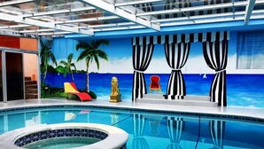 A swimming pool with a tropical mural, a hot tub, and a red lounge chair. - El Santuario Estate (Los Naranjos)