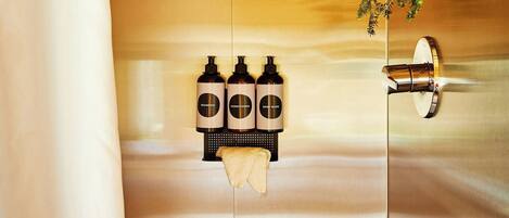 A bathroom with wooden ceiling, a shower, and a hanging plant.