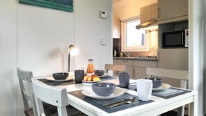 A modern kitchen with white cabinets, a built-in microwave, and a window above the sink. - Amazing home in Heinkenszand with WiFi (Heinkenszand)
