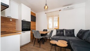 A compact living space with a kitchenette, a dining area, and a seating area.
