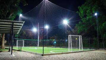 A sports field with a goalpost and floodlights.