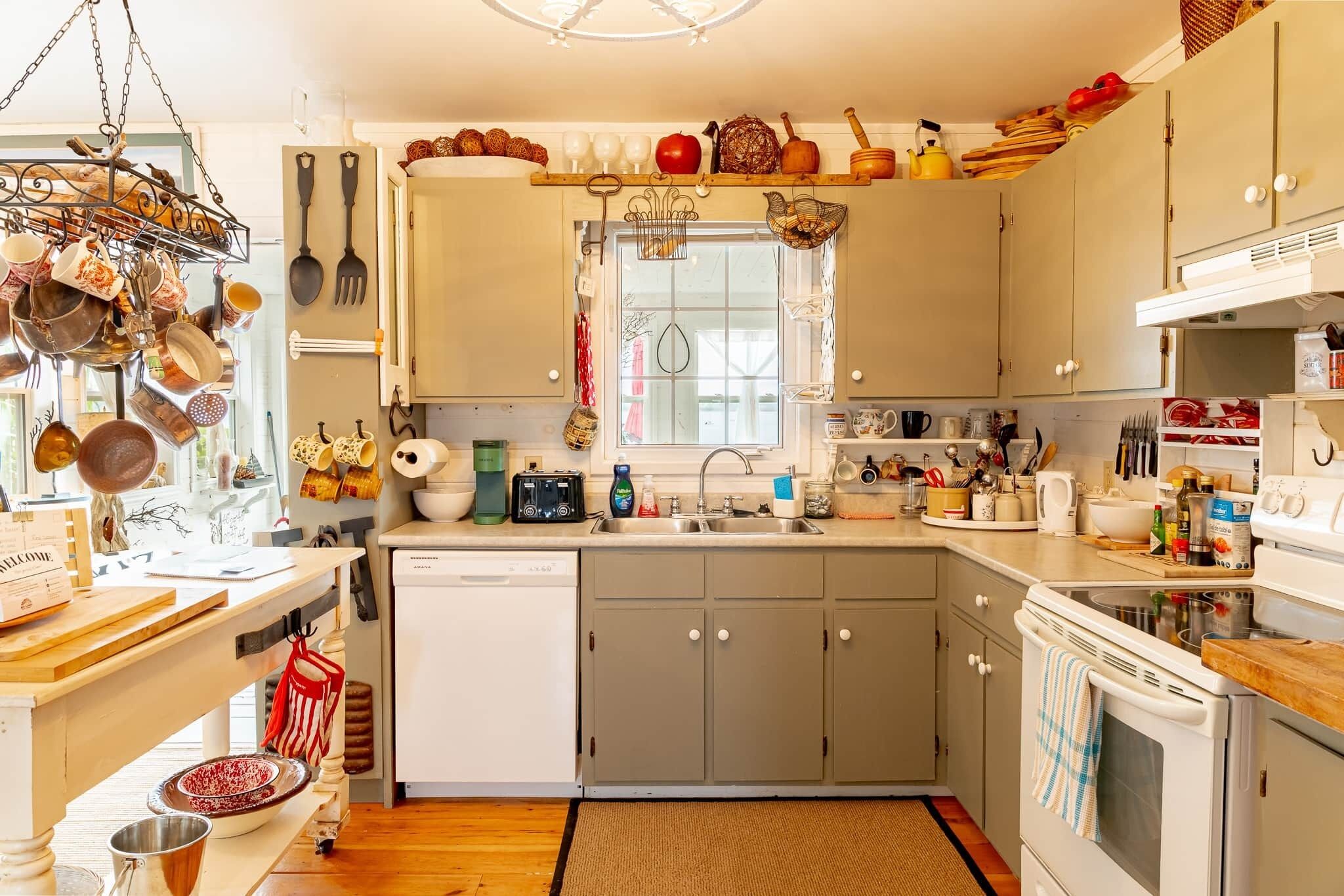 A kitchen with a wooden countertop, a dishwasher, and a stove.