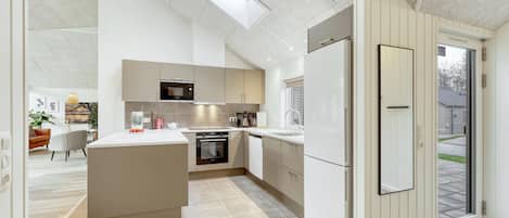 Fridge, stovetop, dishwasher, coffee/tea maker
