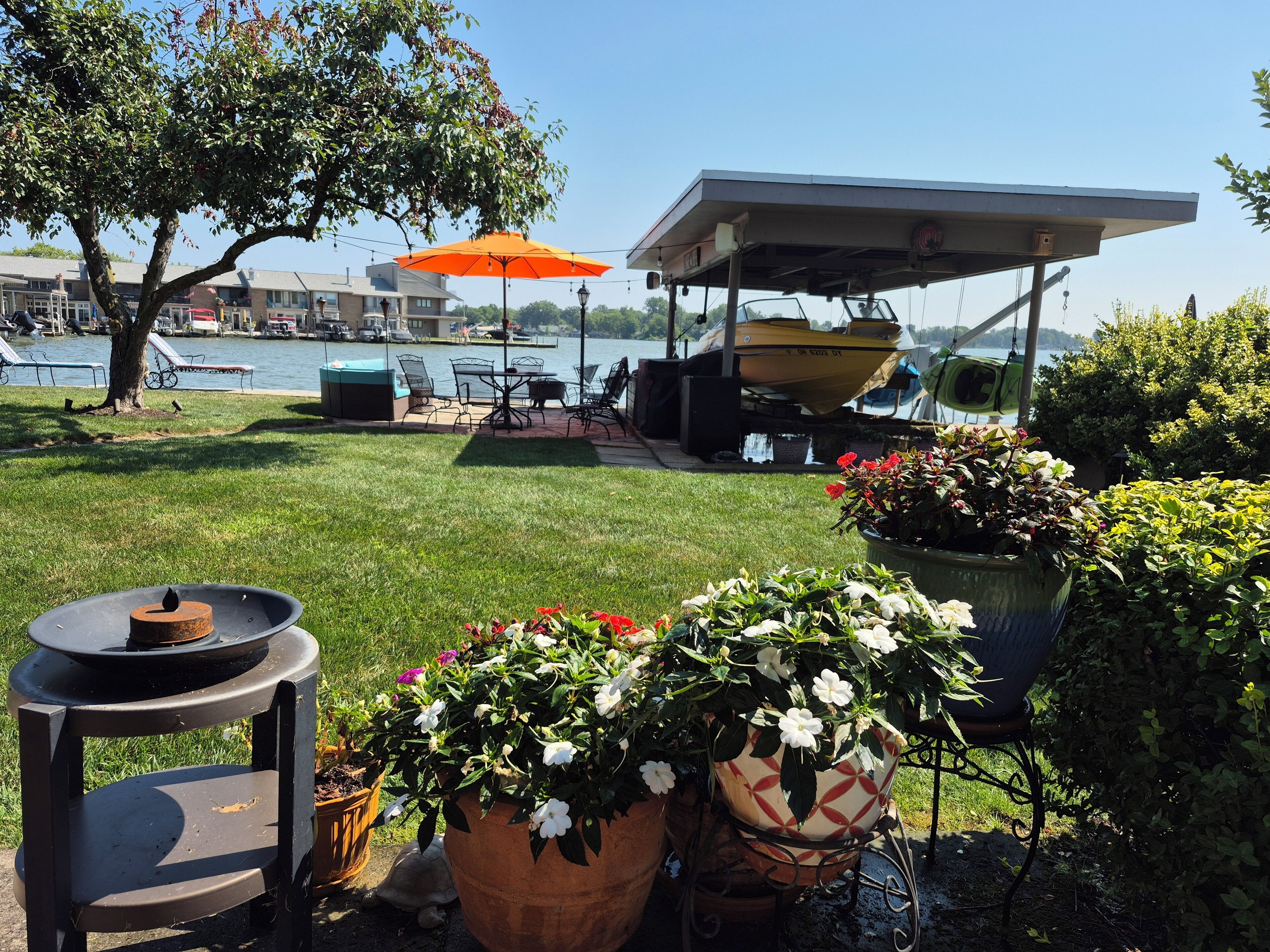 A patio area with outdoor seating, a table with a candle, and potted plants.