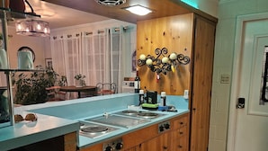 A kitchen with a central island, wooden cabinets, and a built-in stove.