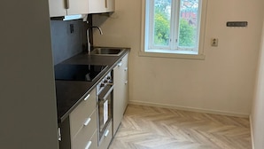 A compact kitchen with a window, a sink, and a stove. - City View Bergen. City and sea views from your private terrace. Very central.  (Vestland)