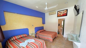 A hotel room with two beds, a ceiling fan, an air conditioning unit, a bathroom with a sink and toilet, and a TV mounted on the wall. - Hotel Xestalito (Santa María Huatulco)