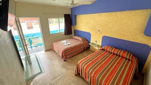 A hotel room with two beds, a ceiling fan, a glass table, and a view of a pool. - Hotel Xestalito (Santa María Huatulco)