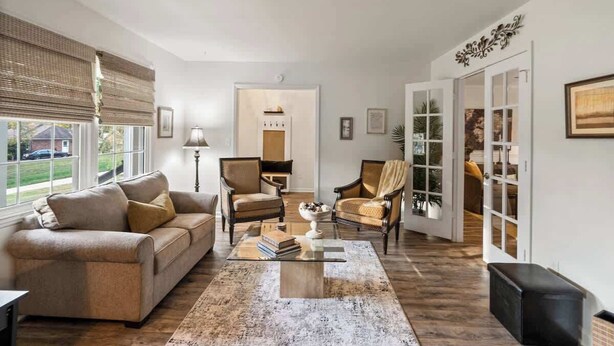 A living room with a sofa, two armchairs, a coffee table, and a fireplace. - Hot Tub - Fire Pit - Single Level Ranch (Matthews)