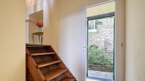 A wooden staircase leading to a door with a glass panel. - Stunning apartment in Recco with kitchen (Recco)