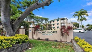 A building labeled "Pacific Shores" with a sign indicating the address "2219 South Kihei Road".