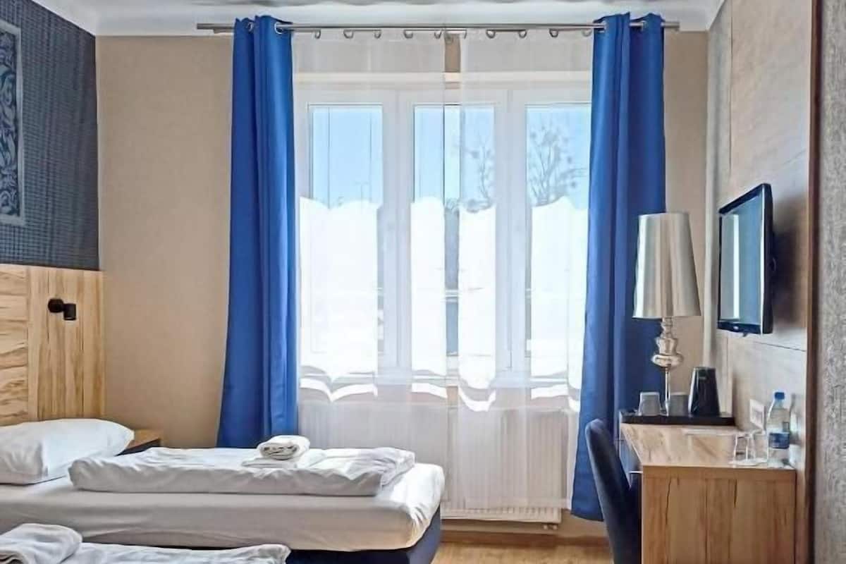 Standard Room | Memory-foam beds, desk, laptop workspace, blackout curtains