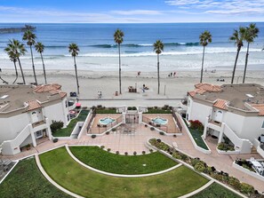 A beachfront hotel with a pool, palm trees, and ocean views. - Breathtaking Oceanview Oceanside Oasis! (Oceanside)