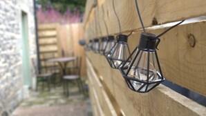 A row of black lanterns hanging on a wooden fence. - The Old Mill Bed & Breakfast (Biggar)